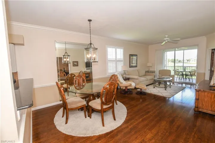 Dining area with hardwood / wood-style floors, ornamental molding, and a wealth of natural light