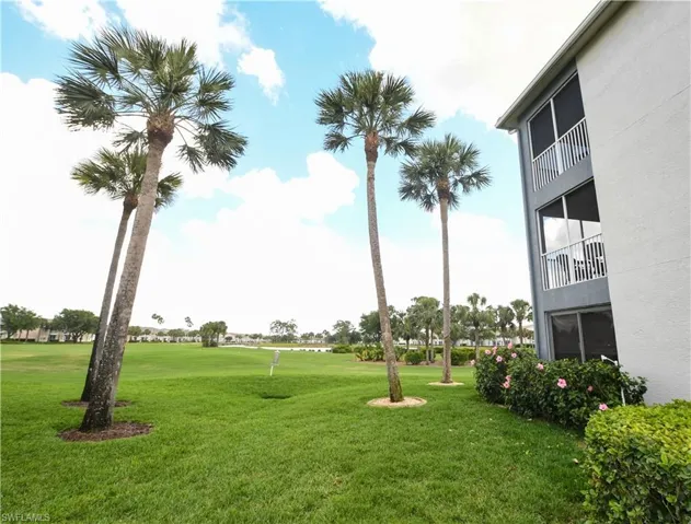 View of home's community with a yard