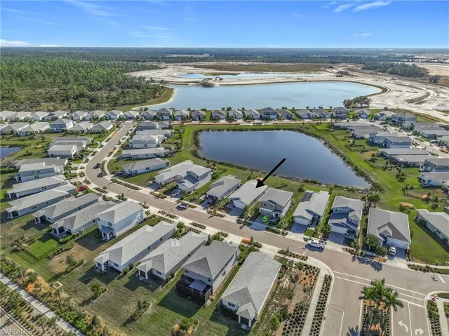 Aerial overview of property's location with a large body of water and nearby suburban area
