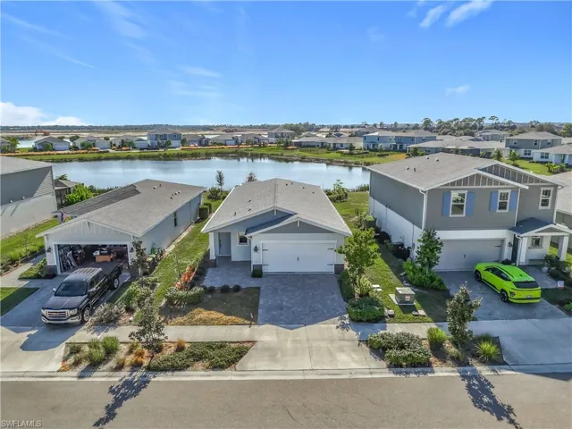 Aerial view of residential area featuring a large body of water