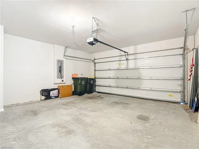 Garage with electric panel and a garage door opener
