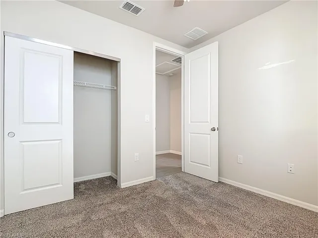 Unfurnished bedroom with carpet floors and a closet