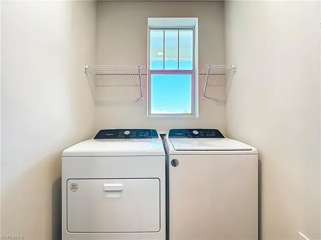 Laundry room featuring washer and clothes dryer