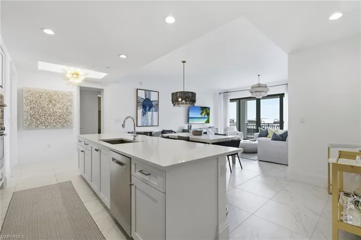 Gourmet kitchen island with an undermount sink and stainless steel dishwasher