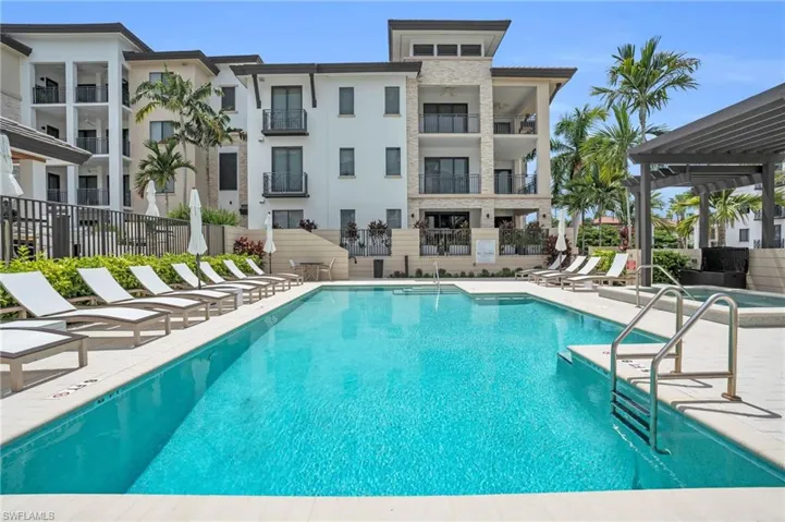Outdoor swimming pool with integrated spa and surrounding lounge areas
