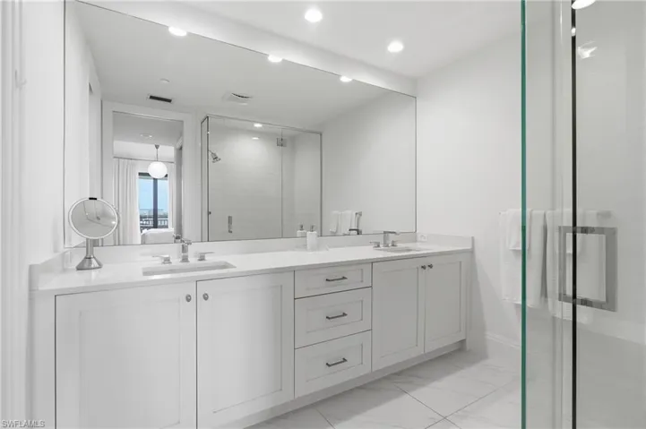 Dual vanity with white cabinetry and integrated sinks