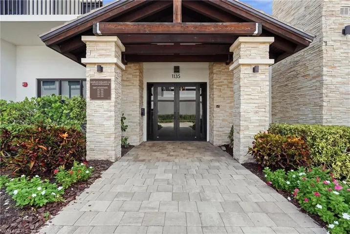 Stone veneer facade with wood-beam entry canopy