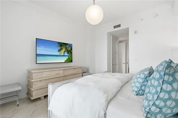 Recessed lighting, crown molding, white painted walls, and tile flooring