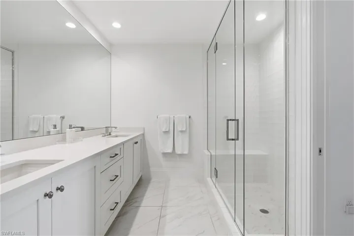 Dual vanity with integrated sinks and white countertops