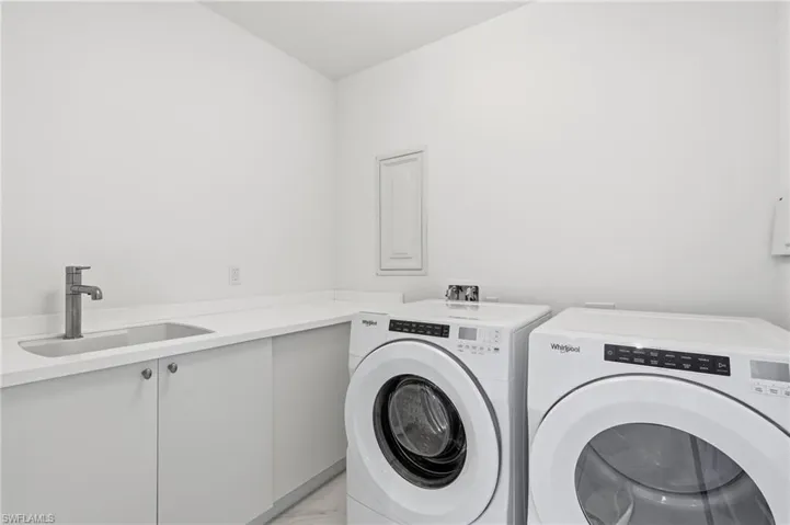 Bright white walls, integrated sink, and a modern single-handle faucet