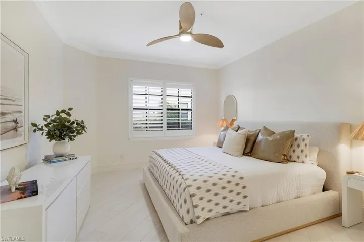 Bedroom featuring ornamental molding and a ceiling fan