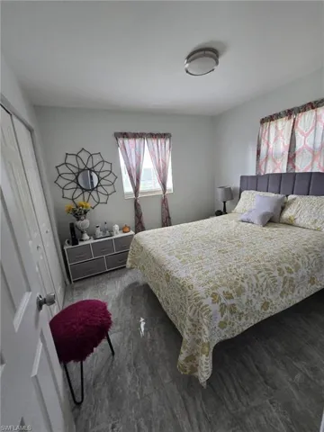 Bedroom featuring dark hardwood / wood-style floors and a closet