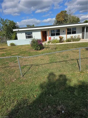 Single story home with a front lawn