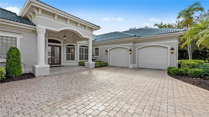 Main entrance with spacious garages including electric charging outlet