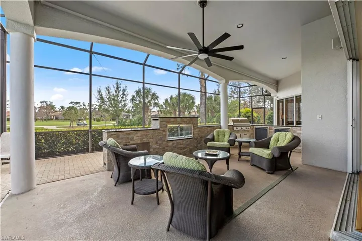 Another gathering area complete with a propane fireplace and outdoor kitchen