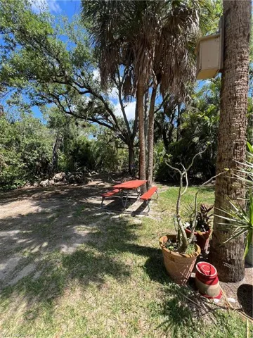 Landscaped grounds featuring mature trees and a picnic area