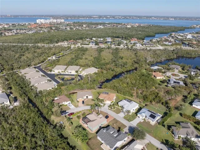 Birds eye view of property featuring a water view and a residential view