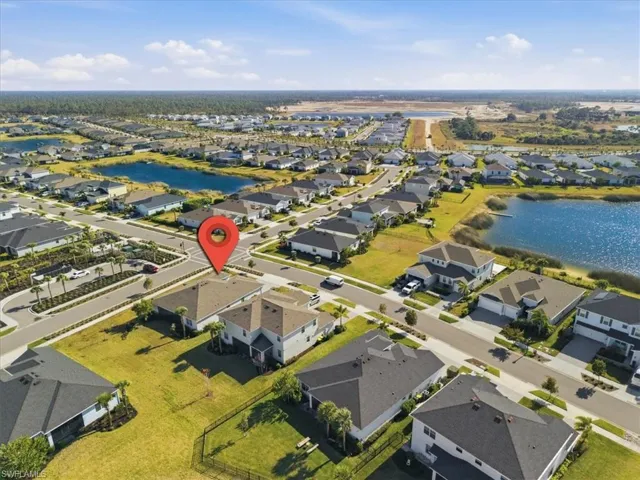 Aerial perspective of suburban area featuring a large body of water