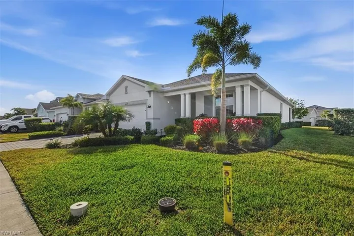 Ranch-style house featuring stucco siding, driveway, a front lawn, and an attached garage