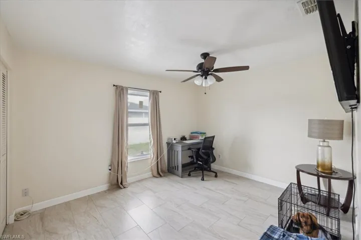 Office space featuring light tile patterned flooring and ceiling fan