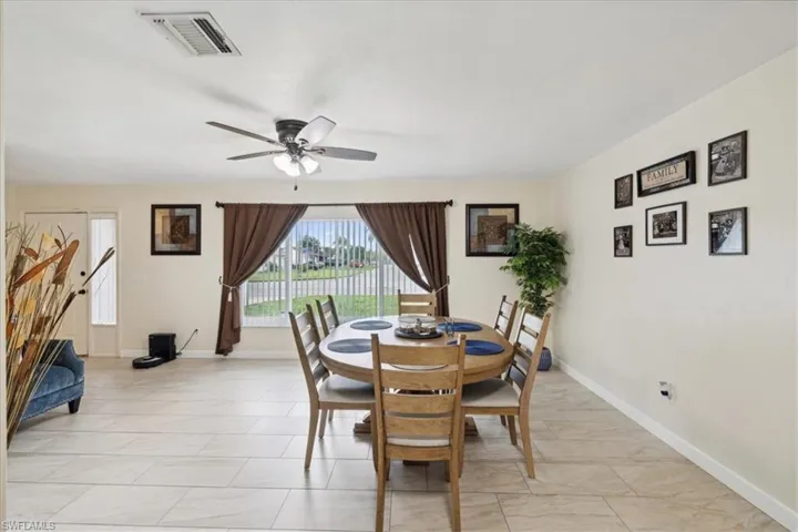 Tiled dining room with ceiling fan