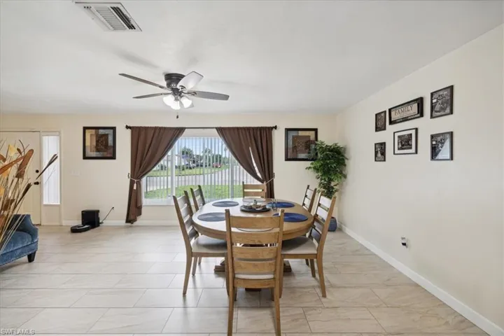 Dining space with light tile patterned floors and ceiling fan