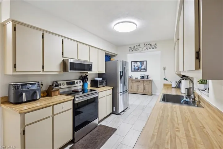 Kitchen featuring light hardwood / wood-style floors, appliances with stainless steel finishes, and sink
