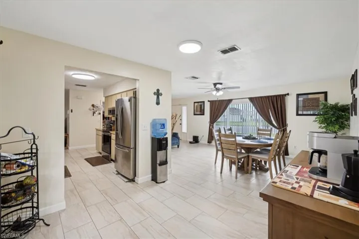 Dining area featuring light tile patterned flooring and ceiling fan