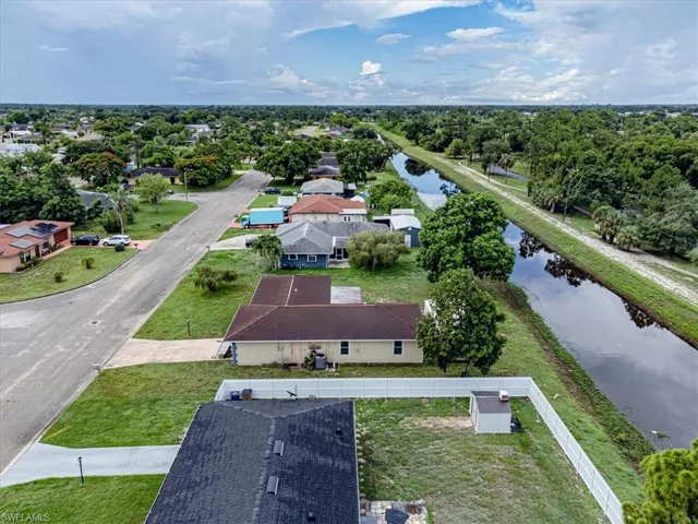 Birds eye view of property with a water view