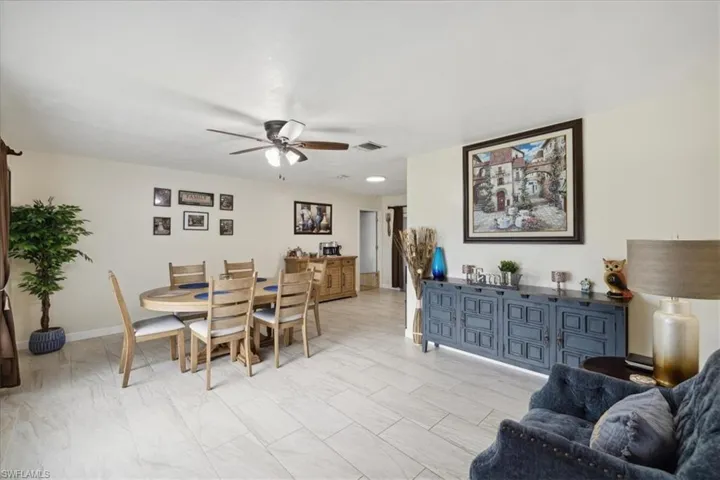 Dining space featuring light tile patterned floors and ceiling fan