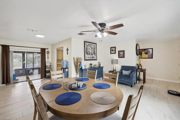 Tiled dining space featuring ceiling fan