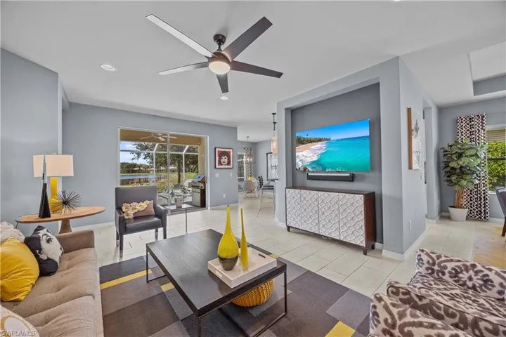 Great room with light tile patterned floors and ceiling fan