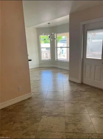 Property entrance with stucco siding and covered porch