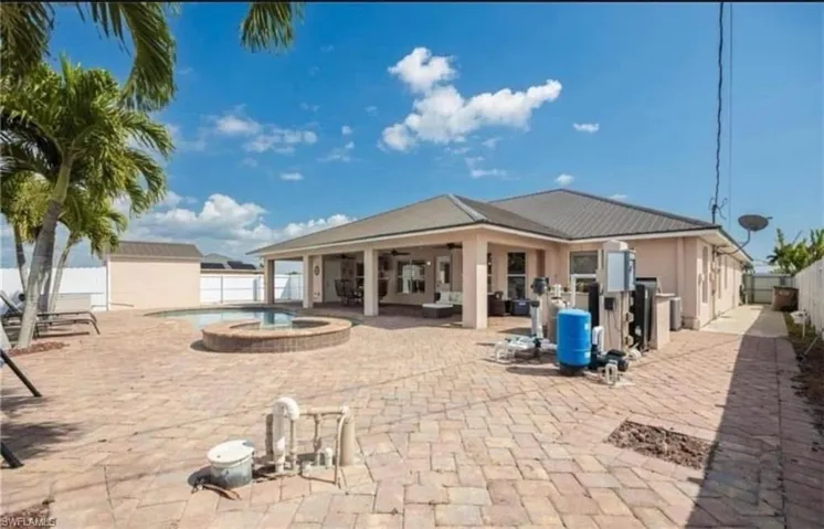 View of pool with a patio area, a fenced backyard, a pool with connected hot tub, and an outdoor hangout area