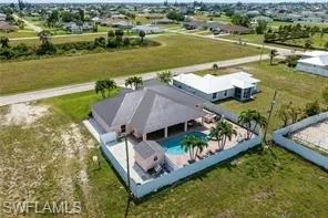 Aerial view of property and surrounding area with a pool area