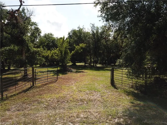 View of yard with fence and a gate