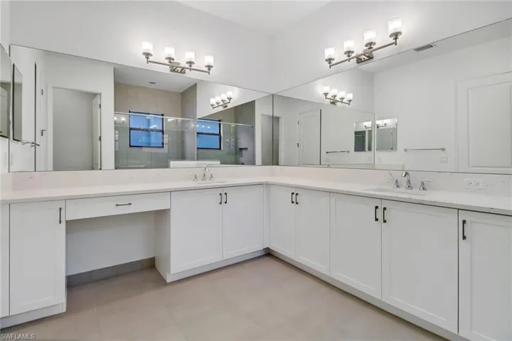 Bathroom with vanity and a shower with door