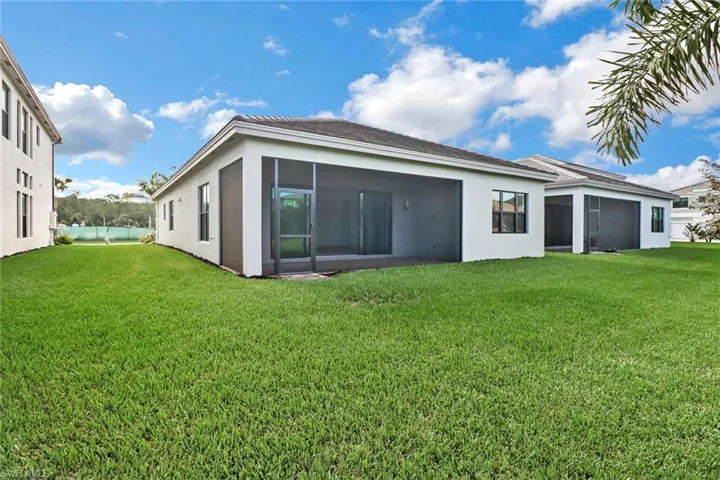 Back of house with a yard