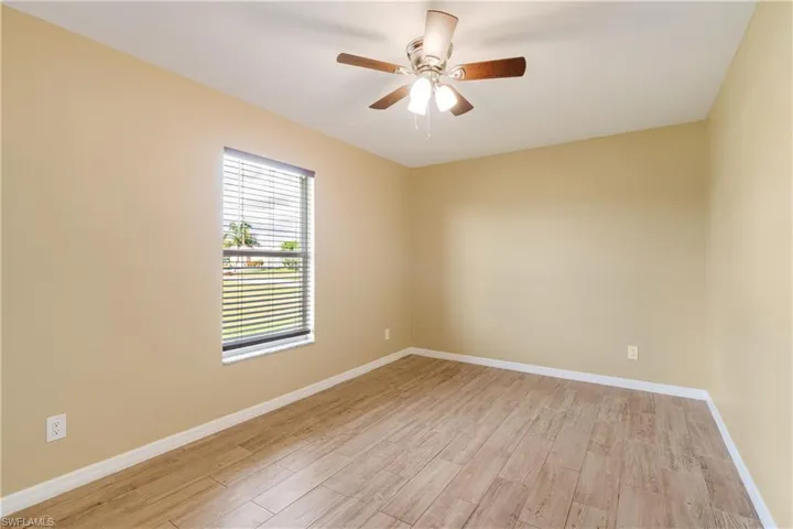 Unfurnished room with light hardwood / wood-style flooring and ceiling fan