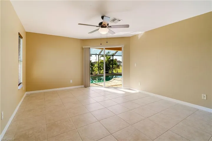Unfurnished room featuring ceiling fan and light tile patterned flooring