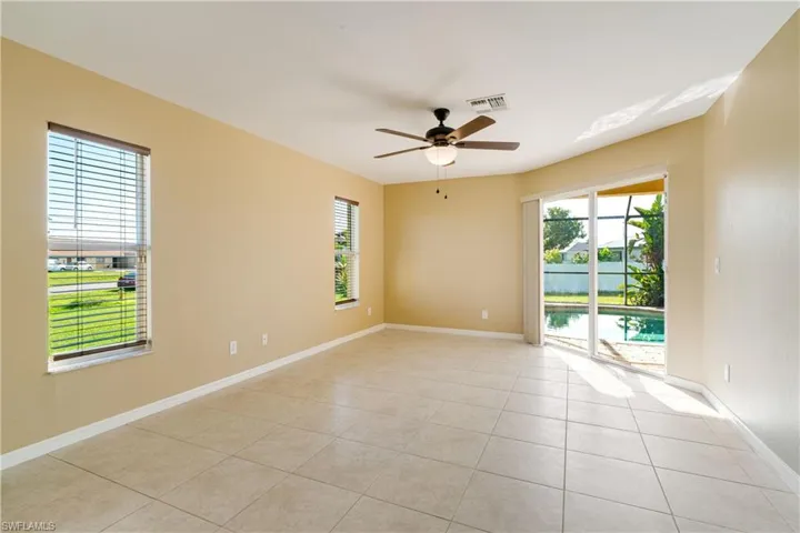 Tiled spare room with ceiling fan