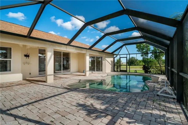 View of pool featuring a patio and screen enclosure