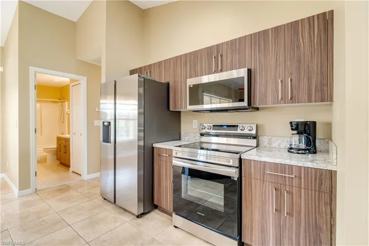 Kitchen featuring appliances with stainless steel finishes and light tile patterned flooring