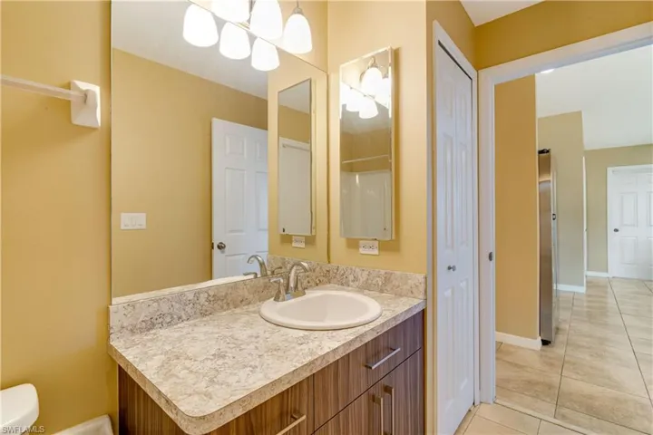 Bathroom with vanity, tile patterned flooring, and toilet