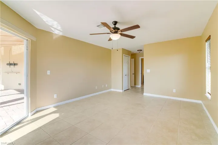 Tiled spare room with ceiling fan