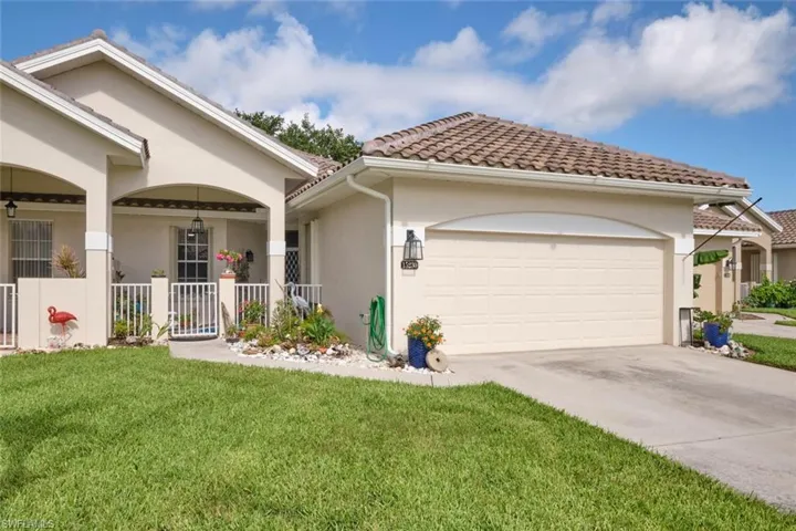 View of front of house featuring a garage and a front lawn