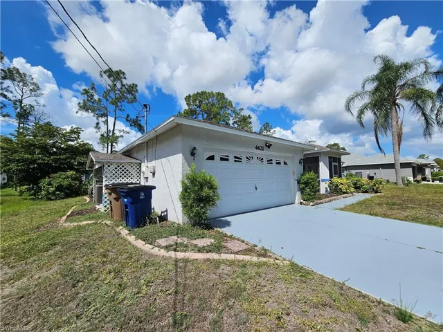 Single-story residence featuring a white exterior and a two-car garage