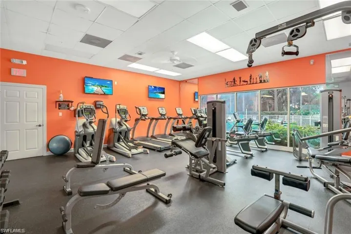 Exercise room with a drop ceiling and a ceiling fan