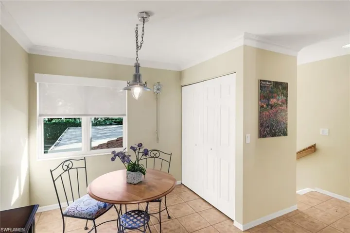 Dining room featuring crown molding and light tile patterned floors