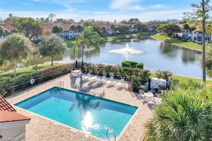 Community pool featuring a water view and a patio area